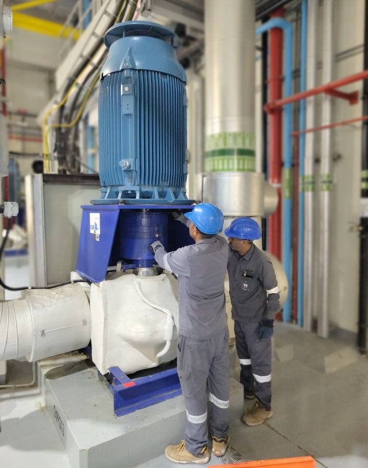 PAL Cooling LLC technicians inspecting control panels for district cooling system operations