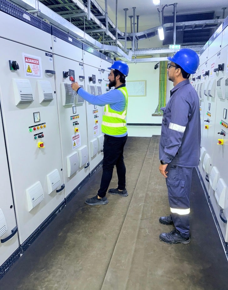 Engineers at PAL Cooling LLC performing maintenance on a district cooling system pump unit